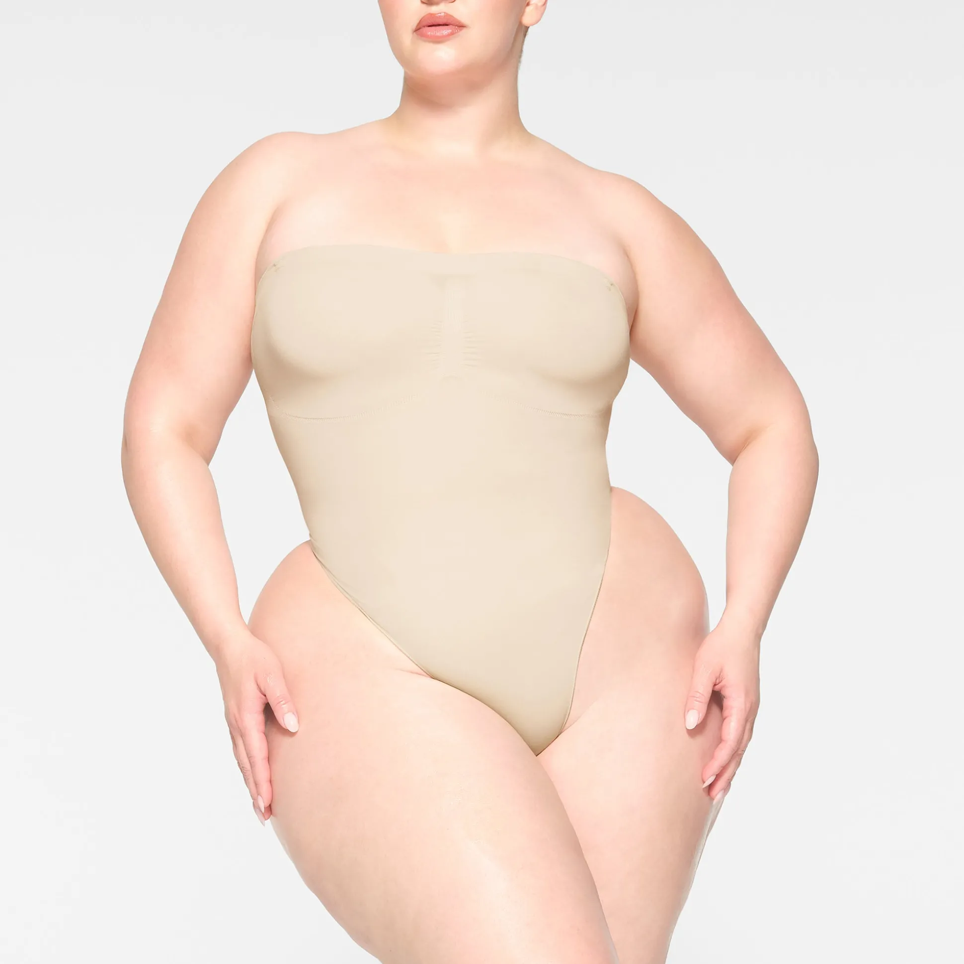 SEAMLESS SCULPT STRAPLESS THONG BODYSUIT | SAND