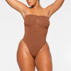 SEAMLESS SCULPT STRAPLESS THONG BODYSUIT | BRONZE